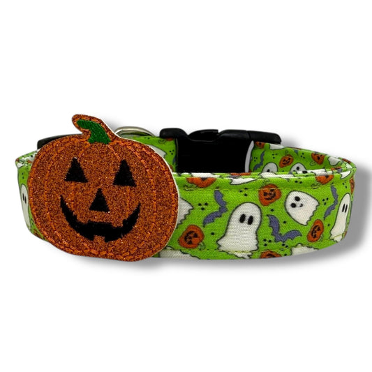 Bright green Halloween dog collar with ghosts, pumpkins, and bats, includes removable shimmery jack-o’-lantern embellishment.