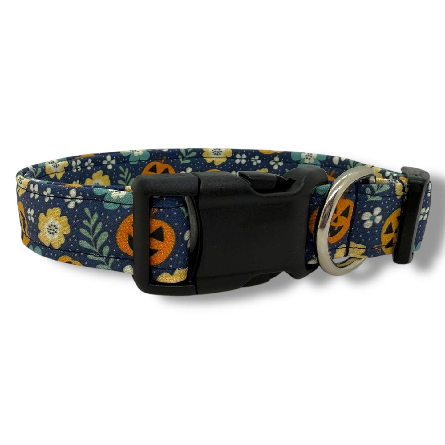 Halloween dog collar with jack-o’-lanterns, and floral accents on a navy background.