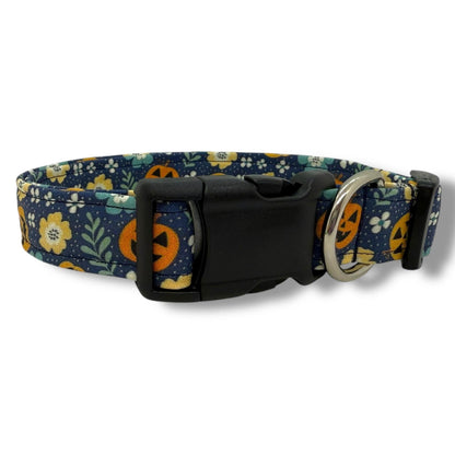 Halloween dog collar with jack-o’-lanterns, and floral accents on a navy background.