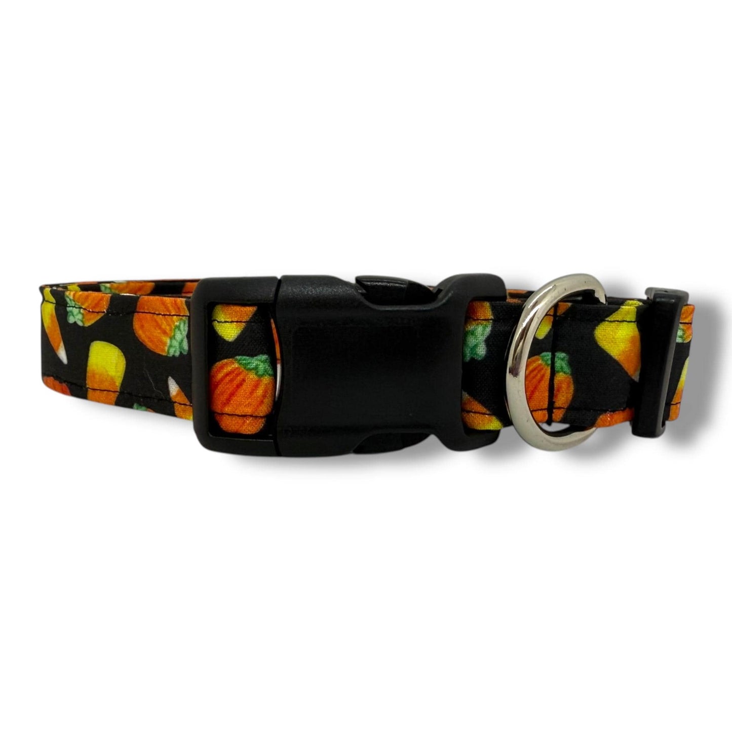 Halloween dog collar with candy corn and pumpkin pattern on black background.