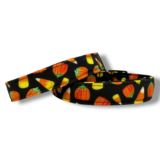 Halloween dog collar with candy corn and mellowcreme pumpkin pattern on a black background for festive fall style.