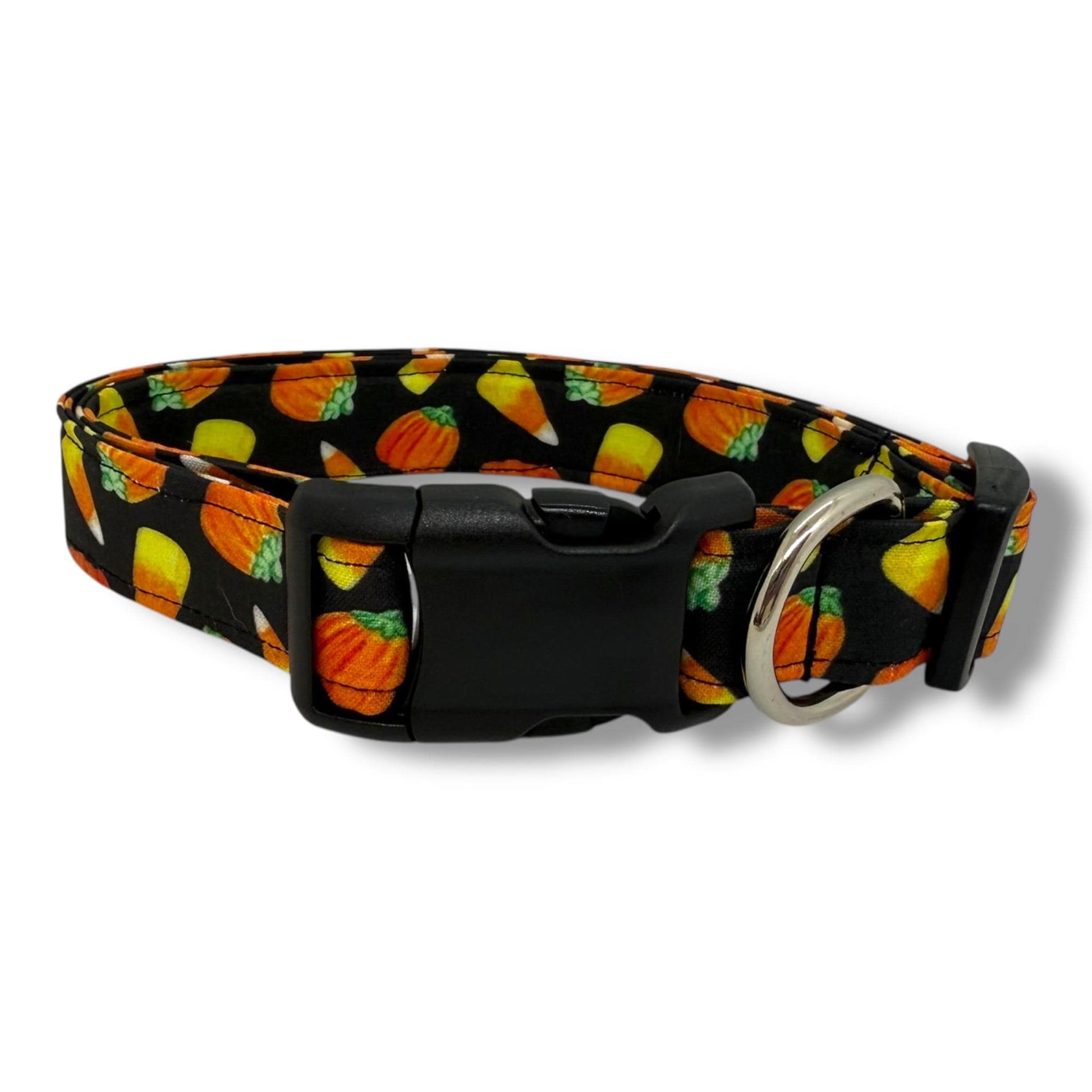 Halloween dog collar with candy corn and pumpkin pattern on black background.