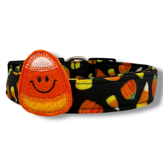 Halloween dog collar with candy corn and pumpkin pattern on black background, includes removable smiling felt candy corn embellishment.