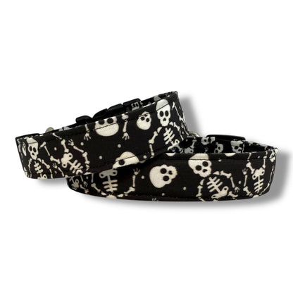 Halloween dog collar with skeletons and skulls on a black background.