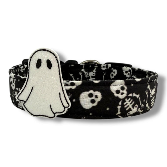 Halloween dog collar with skeleton and skull pattern on a black background, includes removable shimmery ghost embellishment.