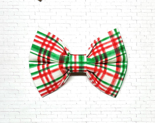 Red and green plaid dog bow tie displayed on a white background, featuring a classic holiday pattern with a festive, timeless look.