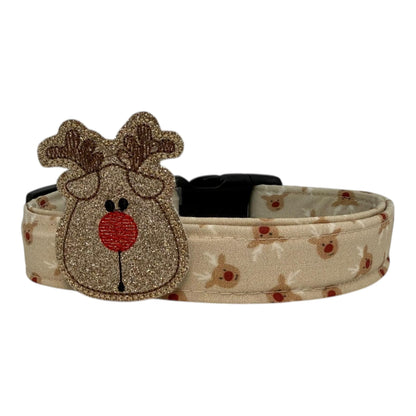 Beige dog collar with small red-nose reindeer faces and a removable reindeer embellishment, adjustable with black buckle and metal D-ring