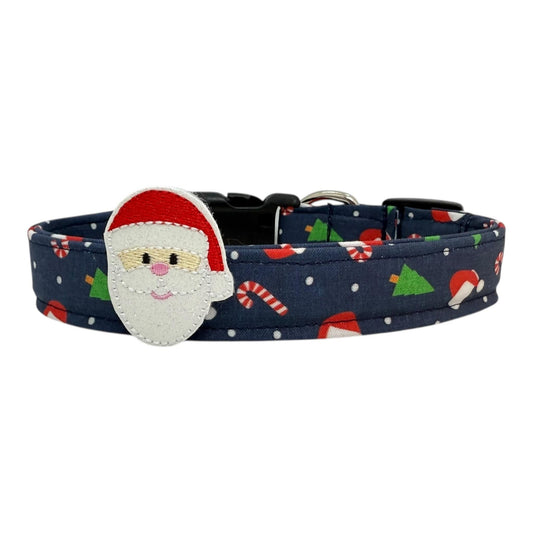 Navy Christmas dog collar with festive holiday icons with removable Santa face embellishment. Handmade with durable nylon webbing, side-release buckle, and welded D-ring. Adjustable sizes XS–XL.