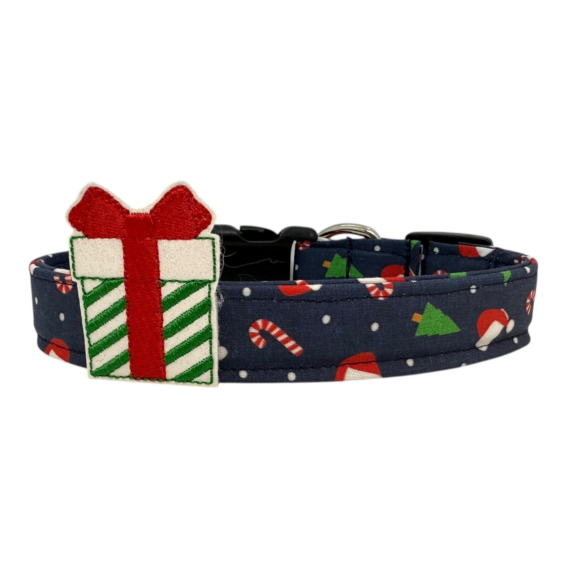 Navy cotton dog collar printed with small Christmas icons, featuring a Christmas gift embellishment, side-release buckle and metal D-ring, handmade and adjustable in multiple sizes.