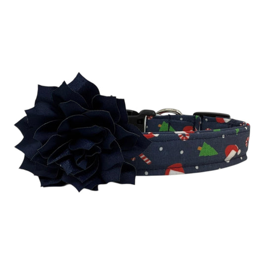 Navy cotton dog collar printed with small Christmas icons, featuring a removable navy dog collar flower, side-release buckle and metal D-ring, handmade and adjustable in multiple sizes