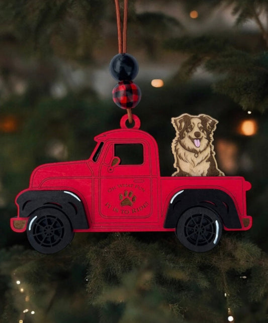 Custom Christmas truck ornament with interchangeable dog breeds, hand-painted details, and rustic leather cord for hanging.